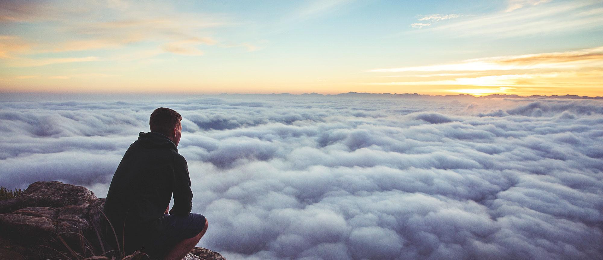 Man Looking Over Clouds