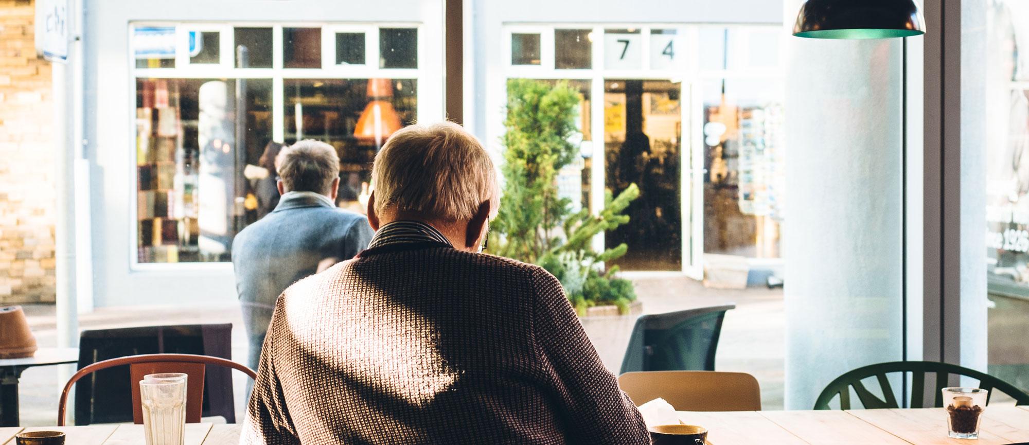 Senior Man Sitting at a Cafe